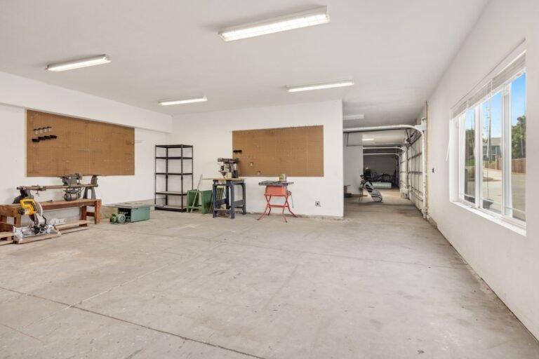 Well-lit garage workshop with LED lighting illuminating organised tools and clean workspace