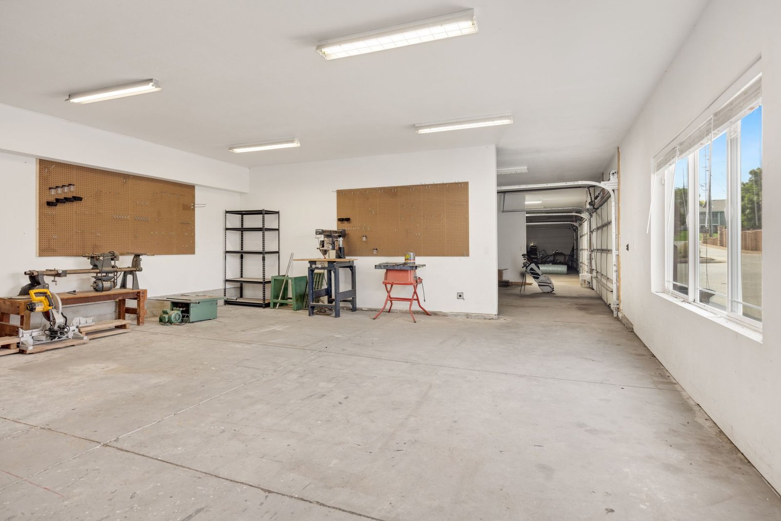 Well-lit garage workshop with LED lighting illuminating organised tools and clean workspace