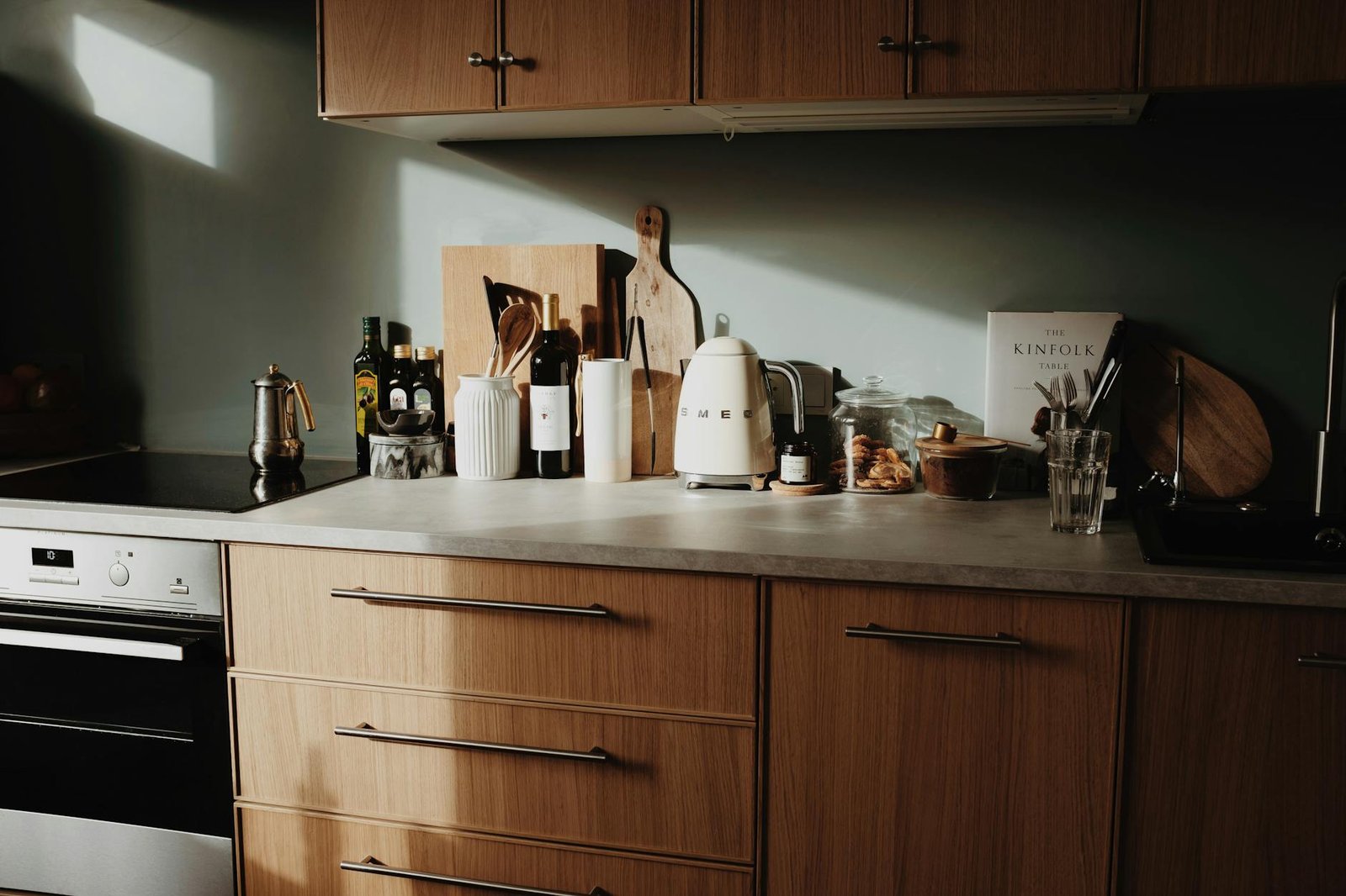Neatly organised kitchen counter with matching containers and utensils in a warm sunlit space
