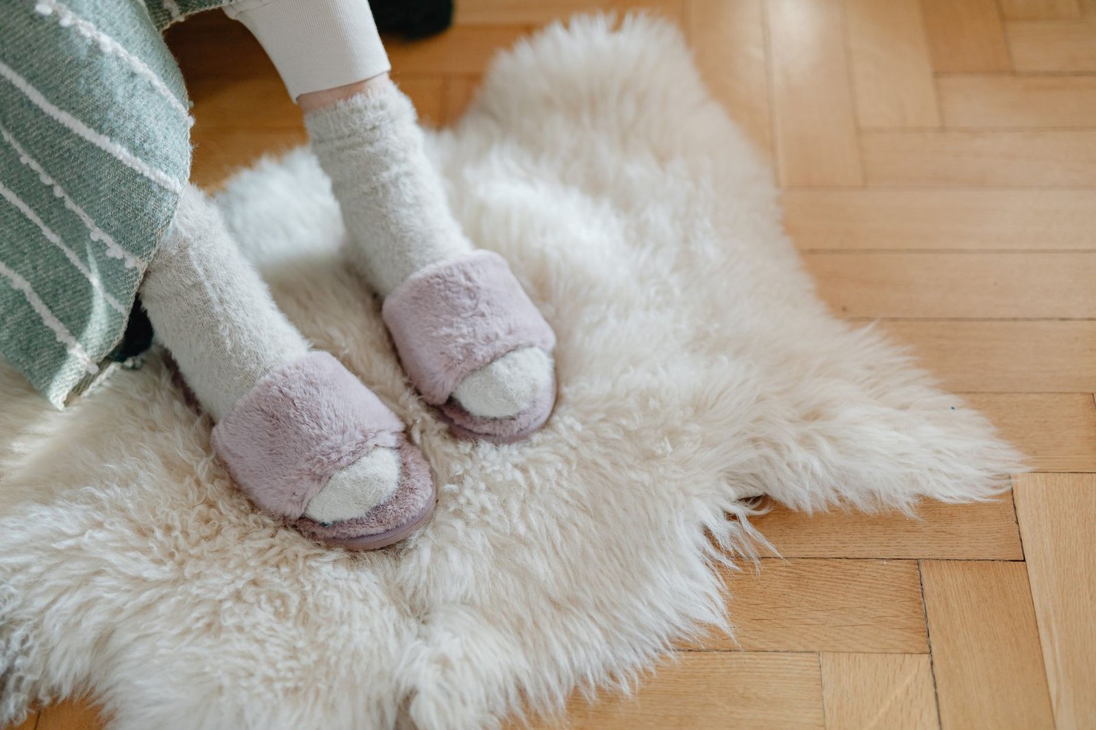 Cozy winter home essentials - warm blankets and ambient lighting for a hygge night in
