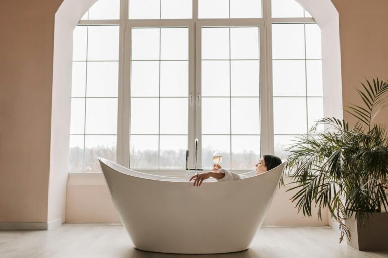 Serene spa-inspired bathroom with natural bamboo accents, soft towels, and calming aromatherapy diffuser creating a luxurious retreat