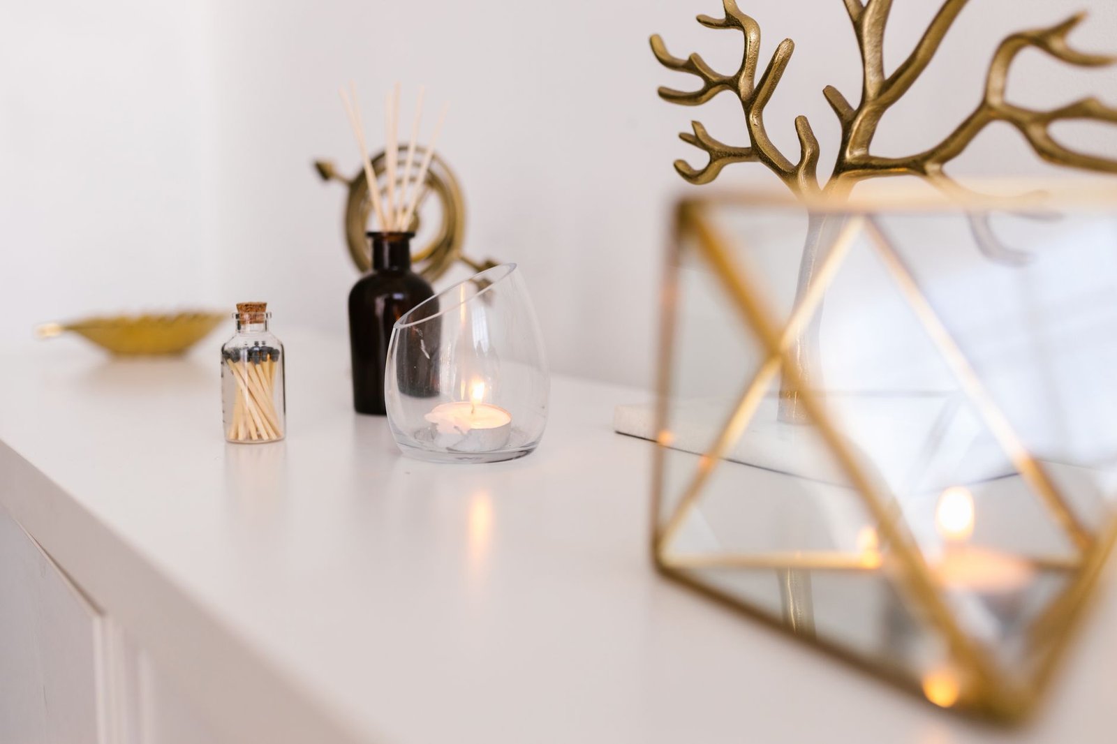 Elegant reed diffuser with rattan sticks on a wooden console table in a bright welcoming living room