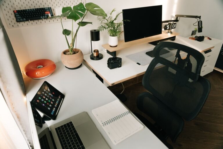 Modern home office with standing desk setup featuring ergonomic accessories and natural light