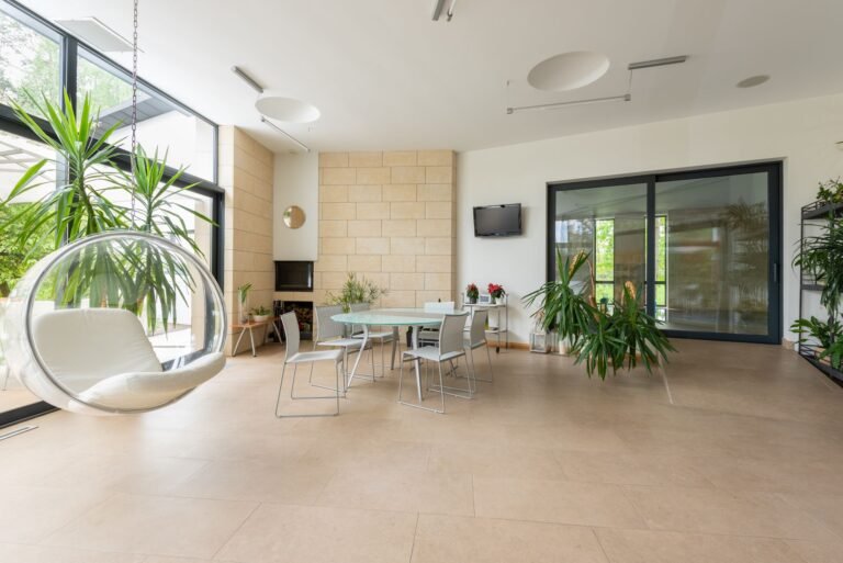 Realistic faux plants arranged in a cozy low-light living room corner with soft ambient lighting
