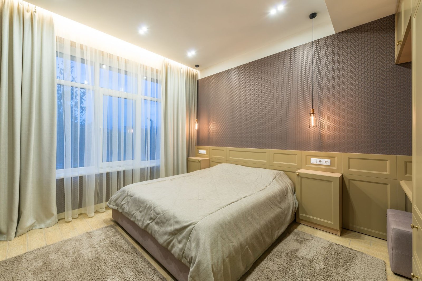 Warm inviting bedroom with soft throw blanket, fairy lights, and velvet cushions creating a cozy atmosphere
