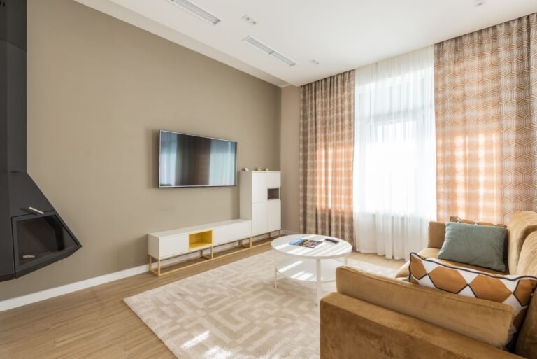 Warm, organized living room with wicker baskets and soft neutral tones creating a clutter-free cozy atmosphere
