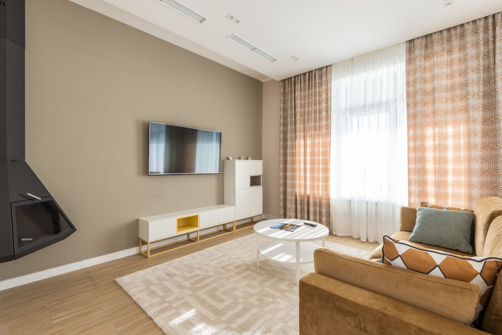 Warm, organized living room with wicker baskets and soft neutral tones creating a clutter-free cozy atmosphere