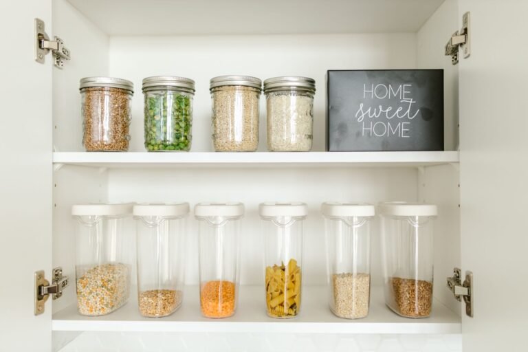 Neatly organized kitchen pantry shelf with jars and containers on a rotating turntable